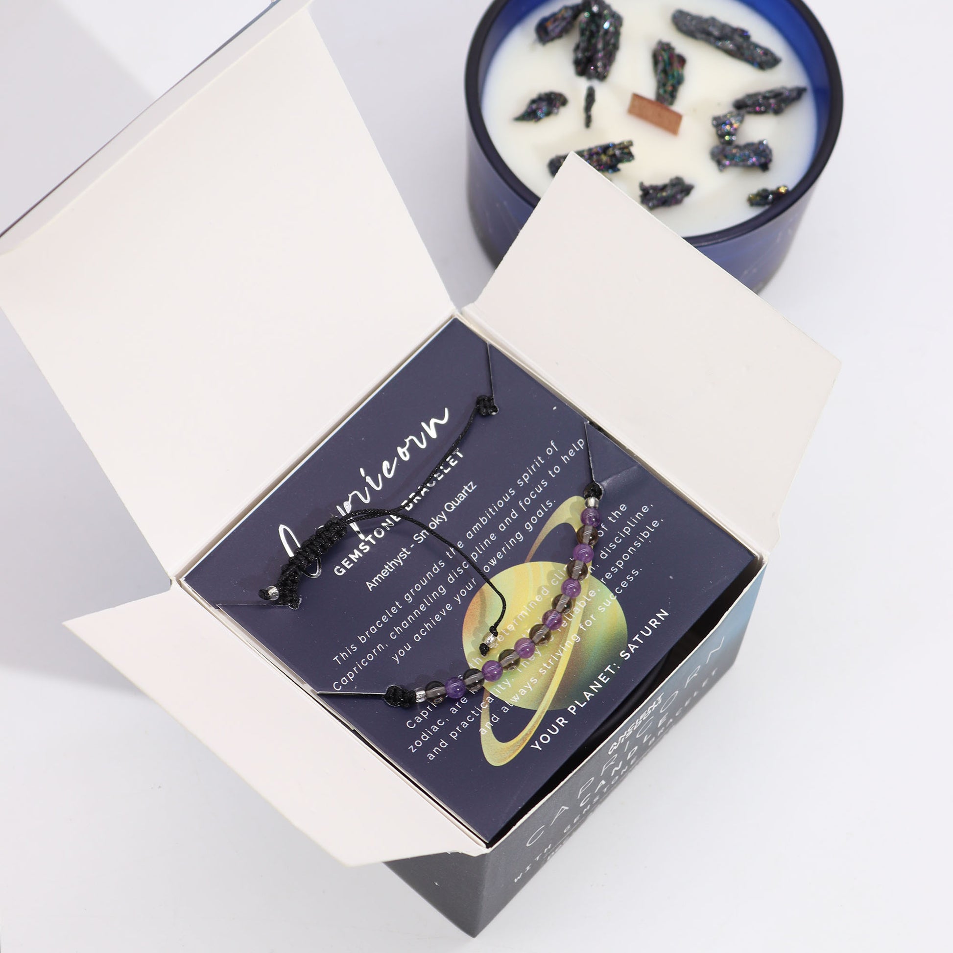 Zodiac Crystal Candle Capricorn with Gemstone Bracelet boxed is beautifully presented in a midnight blue glass jar adorned with silver-embossed star sign constellations.