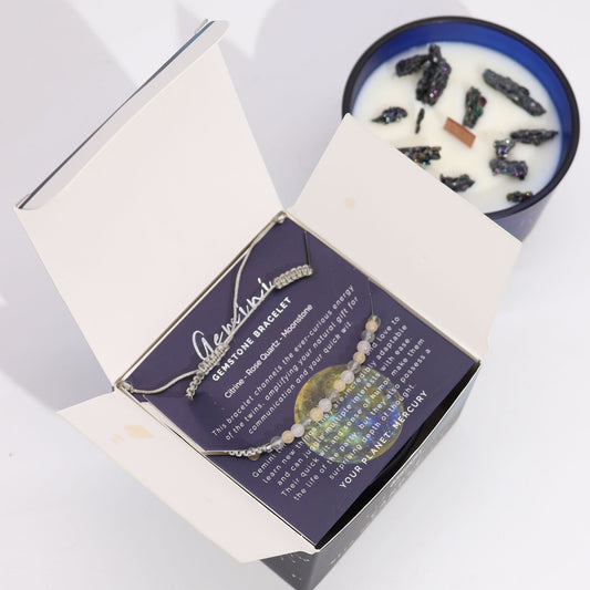 Zodiac Crystal Candle Gemini with Gemstone Bracelet is beautifully presented in a midnight blue glass jar adorned with silver-embossed star sign constellations.