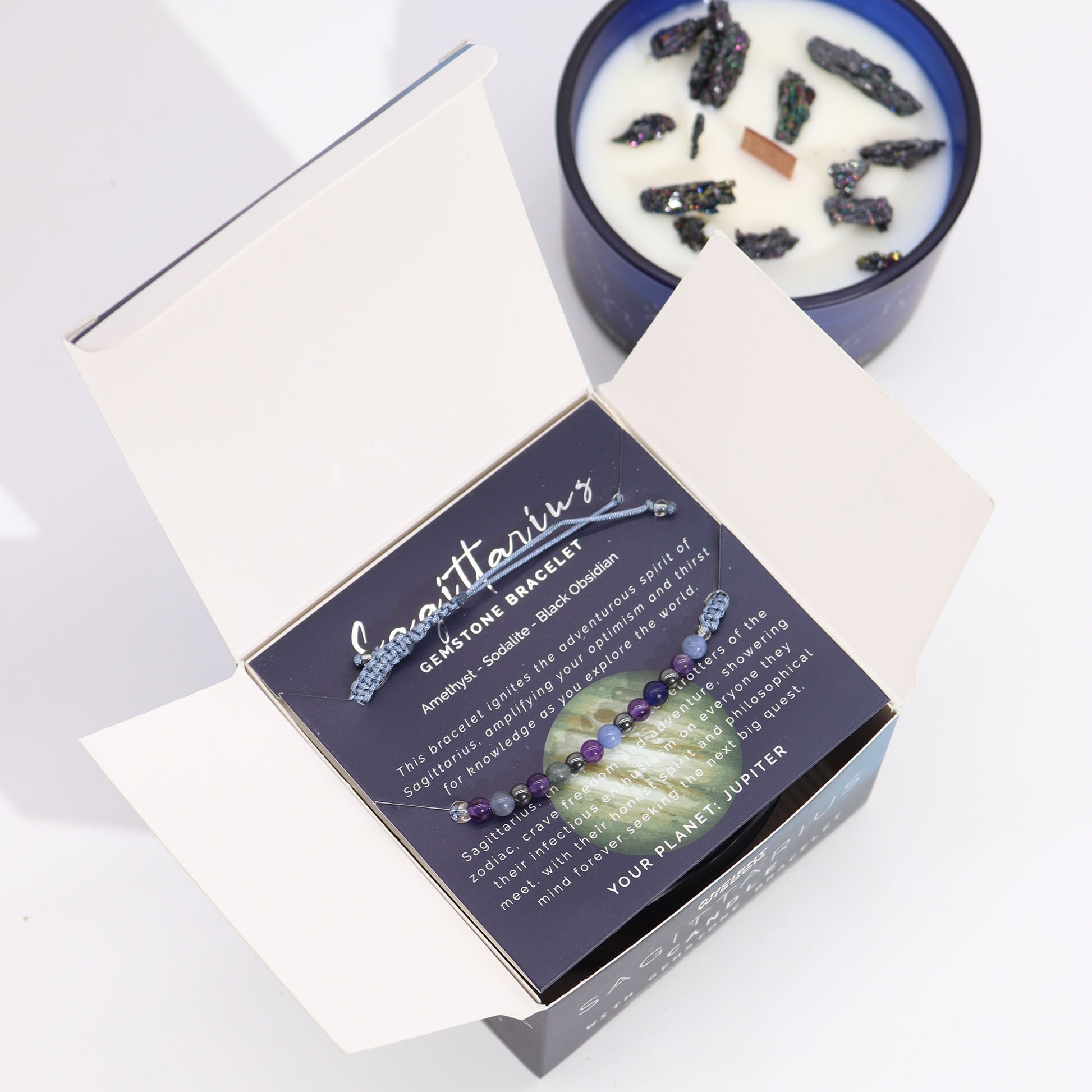 Zodiac Crystal Candle Sagittarius with Gemstone Bracelet boxed is beautifully presented in a midnight blue glass jar adorned with silver-embossed star sign constellations. 