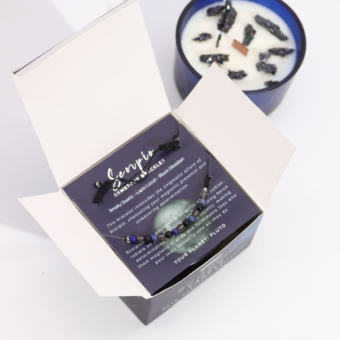 Zodiac Crystal Candle Scorpio with Gemstone Bracelet boxed is beautifully presented in a midnight blue glass jar adorned with silver-embossed star sign constellations.