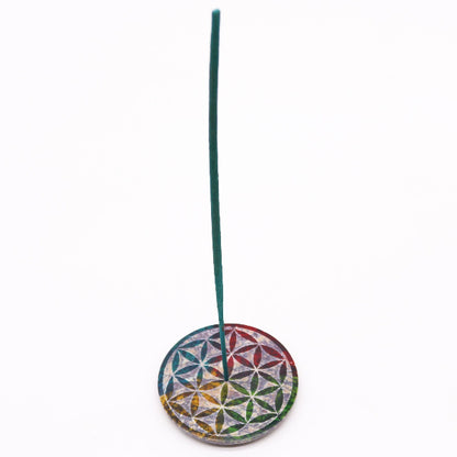 Incense stick holder with a colorful flower design on a white background