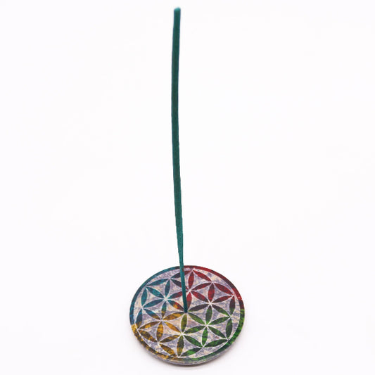 Incense stick holder with a colorful flower design on a white background
