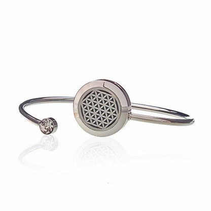 Silver bracelet with a round metal component on a white background