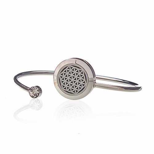 Silver bracelet with a round metal component on a white background