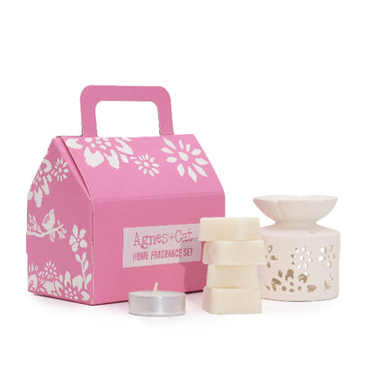 Pink gift box with 'Agnes + Cat' branding, featuring a home fragrance set on a white background.