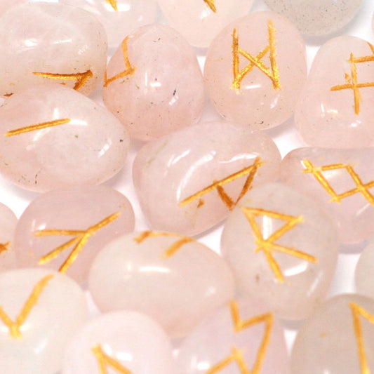 Pink beads with gold symbols on a white background