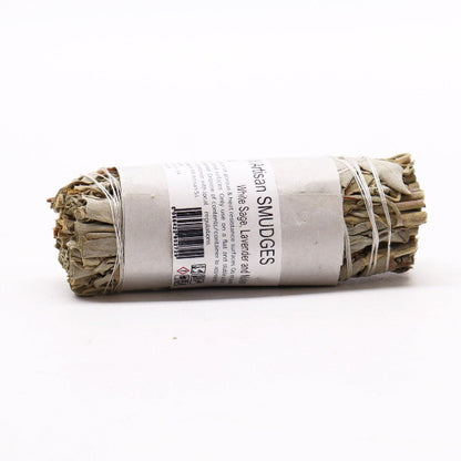 Rolled sage smudge stick with a label on a white background
