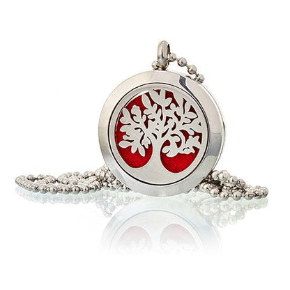 Silver pendant with red center and tree design on a white background