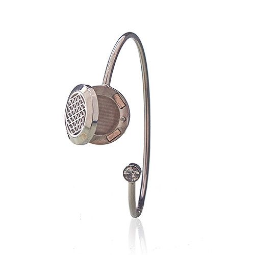 Silver bracelet with a textured metal end on a white background