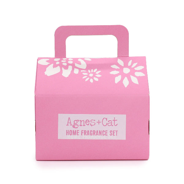 Pink box with floral designs and 'Agnes + Cat' label on a white background