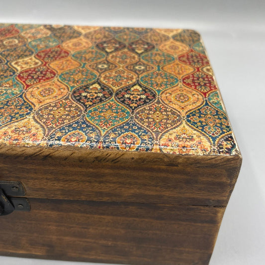 Wooden box with a colorful patterned lid on a white background