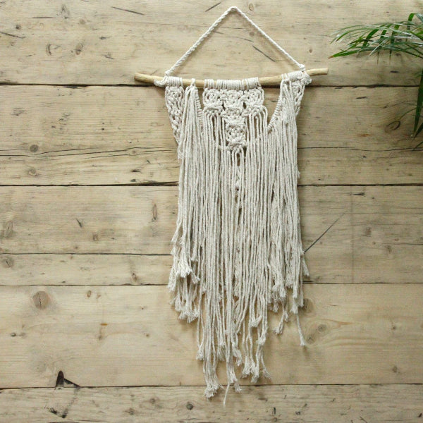 Macrame wall hanging on a wooden wall