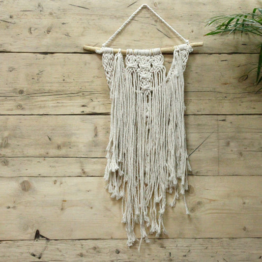 Macrame wall hanging on a wooden wall