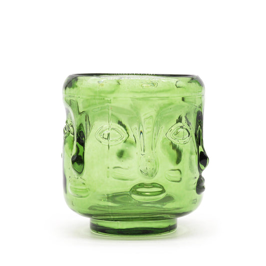 Green glass Buddha candle holder with face design on a white background
