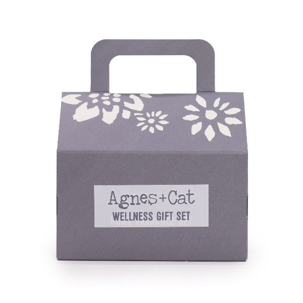 Gray gift box with floral patterns and 'Agnes + Cat Wellness Gift Set' label on a white background