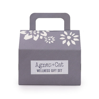 Gray gift box with floral patterns and 'Agnes + Cat Wellness Gift Set' label on a white background