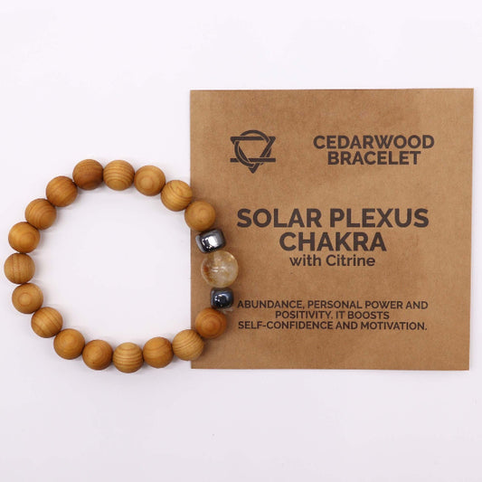 Wooden bracelet with a card explaining its benefits on a white background
