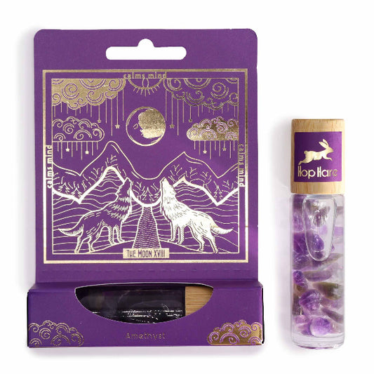 Purple packaging with gold accents featuring a wolf design, next to a clear tube with purple crystals and a rabbit illustration.