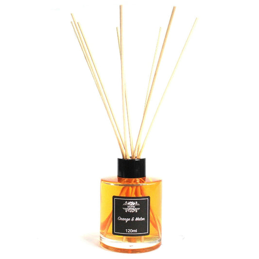 Reed diffuser with orange and black label on a white background