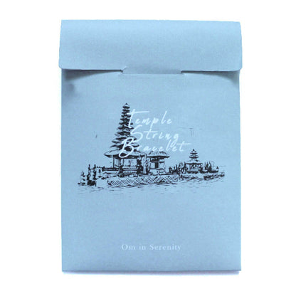 Light blue package with temple design and text on a white background