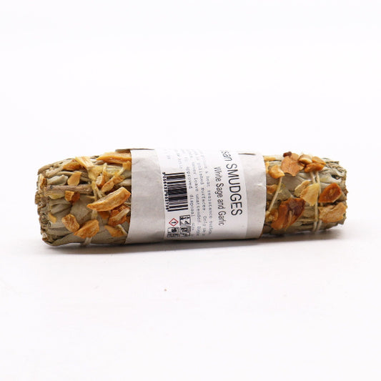 Rolled sage smudge stick with label on a white background