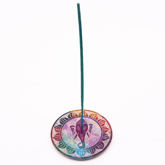 Colorful incense holder with an elephant design on a white background
