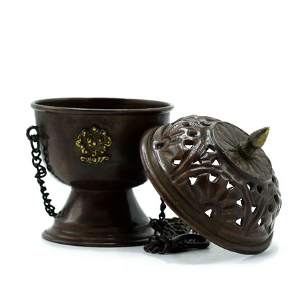 Bronze incense burner with decorative lid on a white background