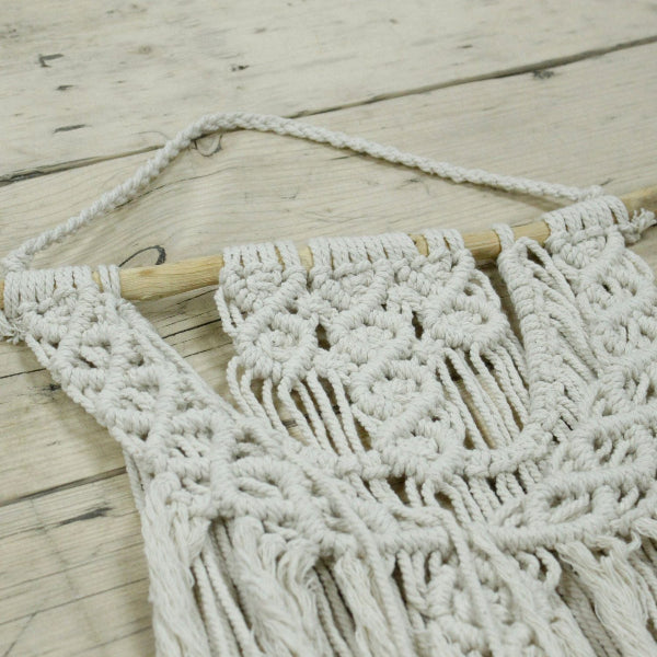 Macrame wall hanging on a wooden surface