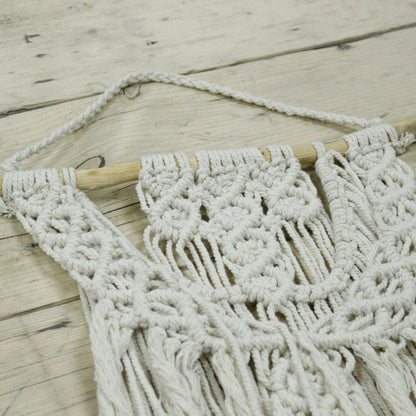 Macrame wall hanging on a wooden surface