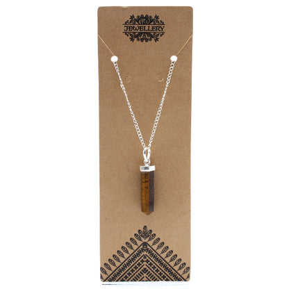 Necklace with a brown pendant on a brown jewelry card