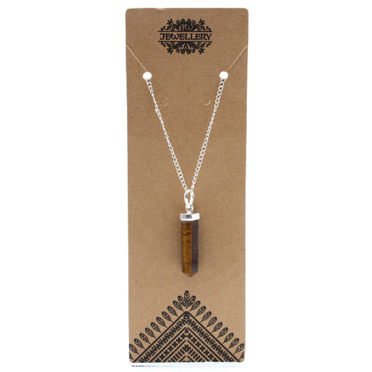 Necklace with a brown pendant on a brown jewelry card