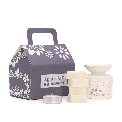Home fragrance set with a decorative box, candles, and a lantern on a white background