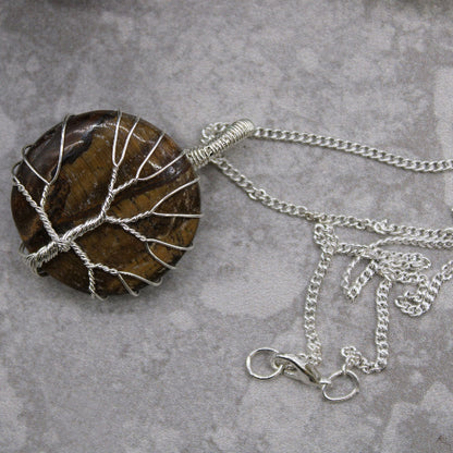 Necklace with a tree-shaped pendant on a gray surface