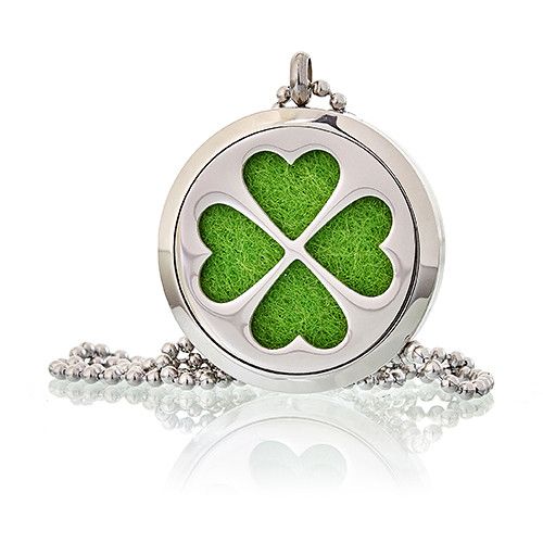 Silver locket with green four-leaf clover design on a white background