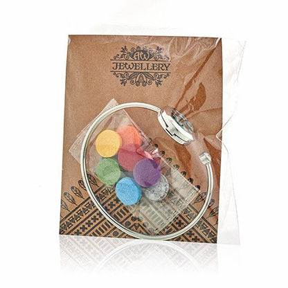 Jewelry set with colorful beads in a clear case on a branded jewelry box.