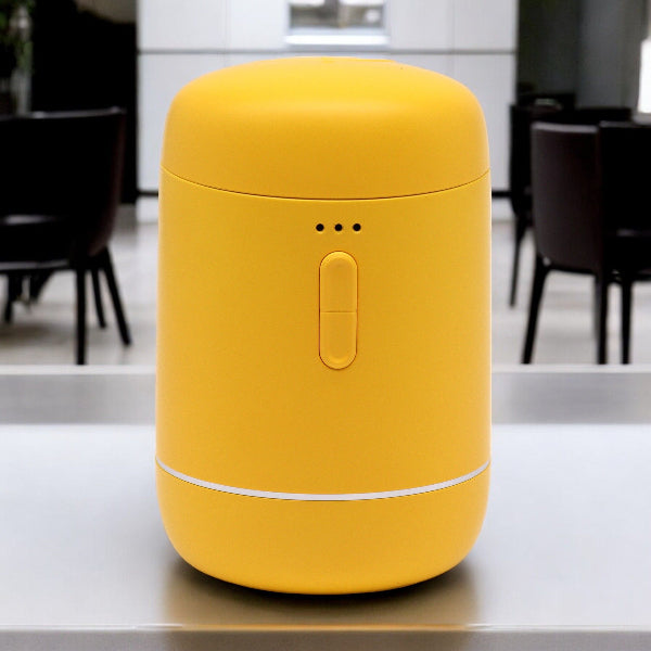 Yellow cylindrical container on a kitchen counter with blurred background