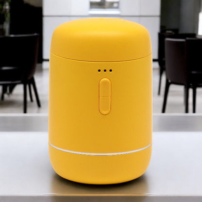 Yellow cylindrical container on a kitchen counter with blurred background