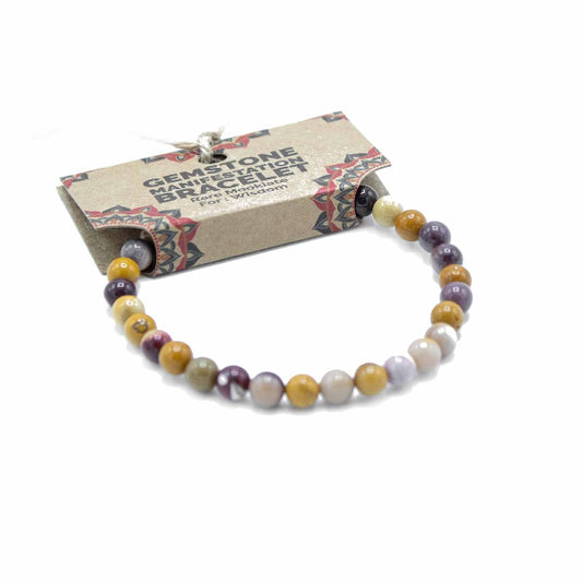 Multicolored beaded bracelet on a white background with a branded card.