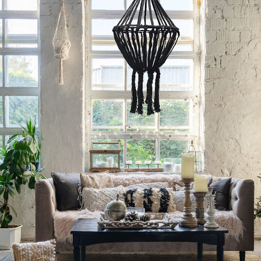 Living room with a black macrame chandelier, sofa, and coffee table.