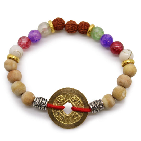 Multicolored beaded bracelet with a gold coin charm on a white background