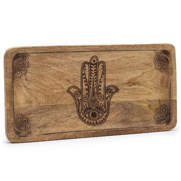 Wooden cutting board with Hamsa hand design on a white background
