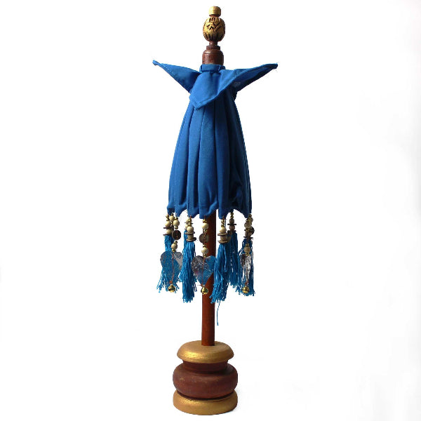 Decorative object with blue fabric and gold accents on a white background