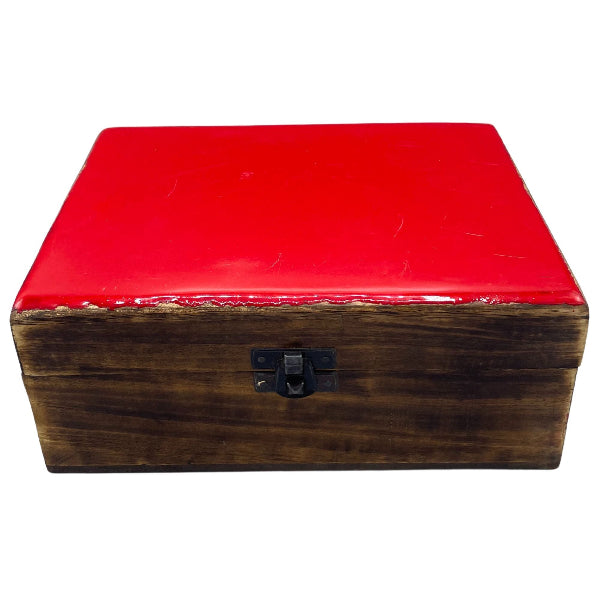Wooden box with a red lid on a white background