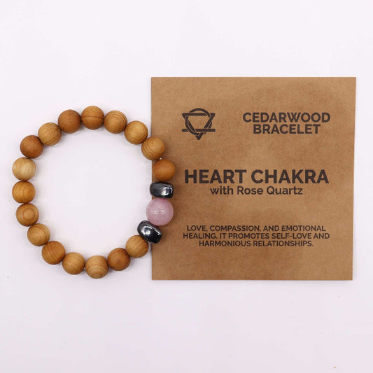 Wooden beaded bracelet with heart chakra stones on a brown card with text