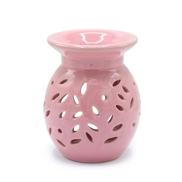 Pink ceramic oil burner with a white background