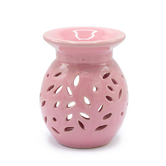 Pink ceramic oil burner with a white background