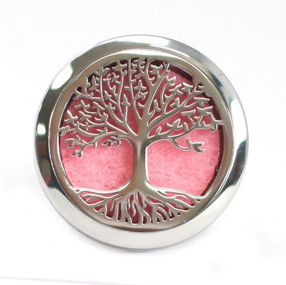 Decorative metal plate with tree of life design on a pink background