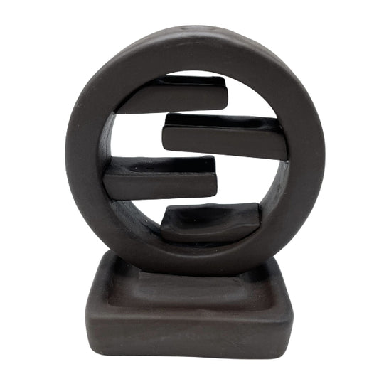 Black abstract sculpture on a white background
