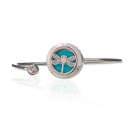Silver bracelet with a dragonfly charm on a white background