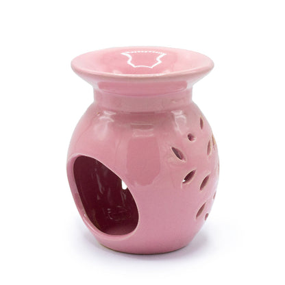 Pink ceramic oil burner on a white background